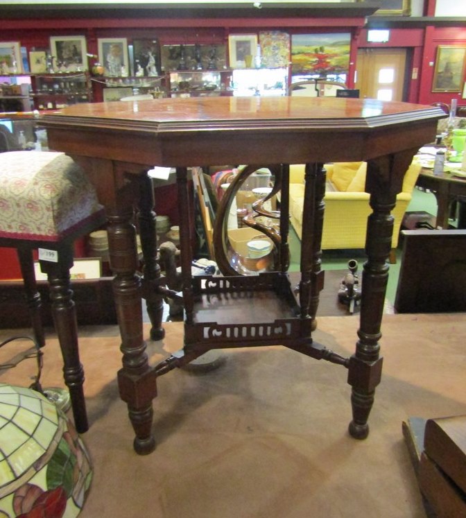 A hexagonal late Victorian occasional table with spindle turned legs, 'X' stretcher with pierced,