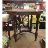 A hexagonal late Victorian occasional table with spindle turned legs, 'X' stretcher with pierced,