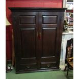 An 18th Century panelled oak country house two door cupboard with key and iron 'H' hinges opening