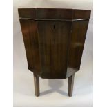A George III octagonal crossbanded mahogany wine cellarette on square legs with tin liner,