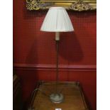 A slender table lamp with silk shade