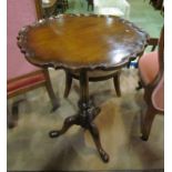 A George III style Chippendale design mahogany wine table the pie crust edge top on turned column