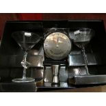 A Dartington glass cocktail set comprising two glasses, recipe wheel, measure,