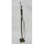 A metal figure of a Nepalese man with staff,