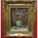 A gilt framed oil on board by J Renier, a large vase of anemones and narcissi, signed lower left.
