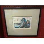 A Japanese woodblock print of mountainous scene, framed and glazed,