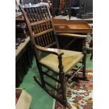Circa 1840 an elm Lancashire spindle back rocking chair the rush seat over a turned front stretcher