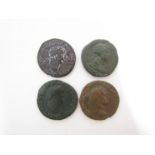 Four Roman bronze coins including two Dupondis of Vespasian (69-79AD) and two of Trajan (98-117AD)