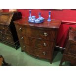 A mid 19th Century crossbanded flame mahogany bow front chest of three graduating long drawers on
