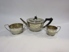 A late Victorian silver tease reeded and engraved with swags comprising of; teapot,