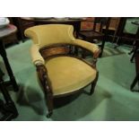 A pair of Edwardian inlaid walnut his/hers bedroom chairs on curved arms on castors