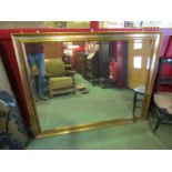 A large gilt frame bevel edge wall hanging mirror.