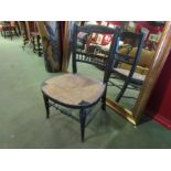 A Victorian ebonised single chair, spindle back, stretcher base,