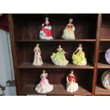 Seven Royal Doulton figures including 'Pretty Ladies' series figurines consisting of spring, summer,