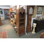 A 1930's mahogany bookcase with gadrooning, three recessed shelves above cupboard a/f,