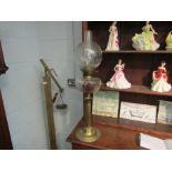 A brass corinthian column pedestal oil lamp with etched shade and glass chimney