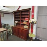 An oak five tier break-front bookcase on two door base,