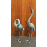 A pair of verdigris heron water feature figures