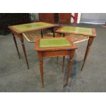 A nest of three reproduction mahogany coffee tables with tooled green leather inserts