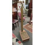 A mahogany set of doctor's weighing scales with upholstered platform and brass measure a/f