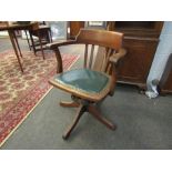 A circa 1900 oak swivel office/desk chair with slatted back and rexine seat