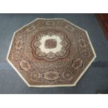 An octagonal wool rug (possibly Wilton) circa late 70's, beige ground with multiple borders,