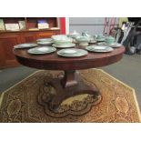 An early Victorian rosewood circular dining table on quatreform base,