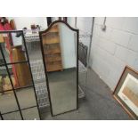 An Edwardian mahogany arched top wall mirror with bevelled edge,