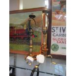 A brass Pullman style carriage table lamp raised on shaped tripod legs with hole to one foot