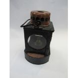 A railway signal lamp interior stamped M&GN JR to one side with copper plaque
