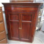 A George III oak two door wall hanging corner cupboard with shaped shelves (damaged),