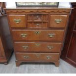 An 18th Century oak chest of four short over three long drawers,