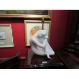 A white ceramic table lamp base in the form of a seated woman