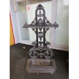 A Victorian cast iron umbrella/stick stand with man mask design,