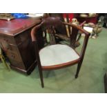 An Edwardian mahogany elbow chair the bow shape back with pierced splats having quatrefoil