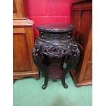 A circa 1900 ebonised Oriental two tier carved jardiniere stand,