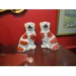 A pair of red and white Staffordshire dogs,