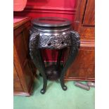 A circa 1900 ebonised Oriental two tier carved jardiniere stand,