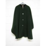 A 1940's Austrian dark green wool cape with metal buttons and black velvet collar