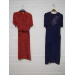 A 1940's red patterned crepe dress CC41 utility label and a 1940's purple crepe dress decorated