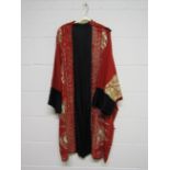 A 1920's red wool kimono style evening coat with cream silk embroidered detail,