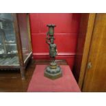 A Regency bronze figural candlestick,