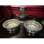An Art Nouveau silver plate wine bottle holder and a pair of coasters