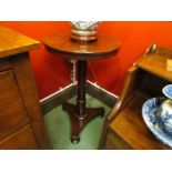 A William IV mahogany circular tilt-top wine table over a tapering cylinder turned column and