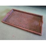 An Indian hardwood carved tray,