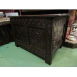 An 18th Century oak two panel coffer the hinged lid over a carved base on stile feet,