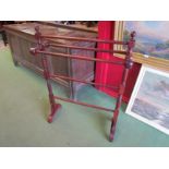 A 20th Century mahogany five bar towel rail with finial tops over turned supports