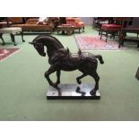 A large bronze war horse on marble base,