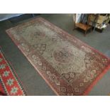 A 19th Century large pink ground runner rug with floral design and multiple borders, repaired, a/f,