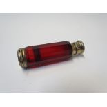 A Victorian ruby glass double ended perfume and smelling salts bottle, dent to lid,
